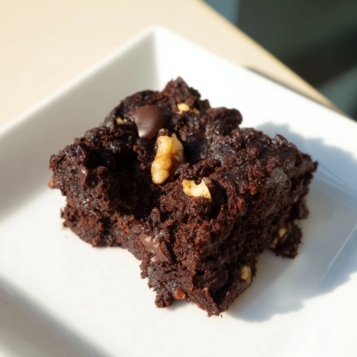 These freshly baked Gluten-Free Almond Flour Brownies look rich, with visible chocolate chips and a slightly cracked top.