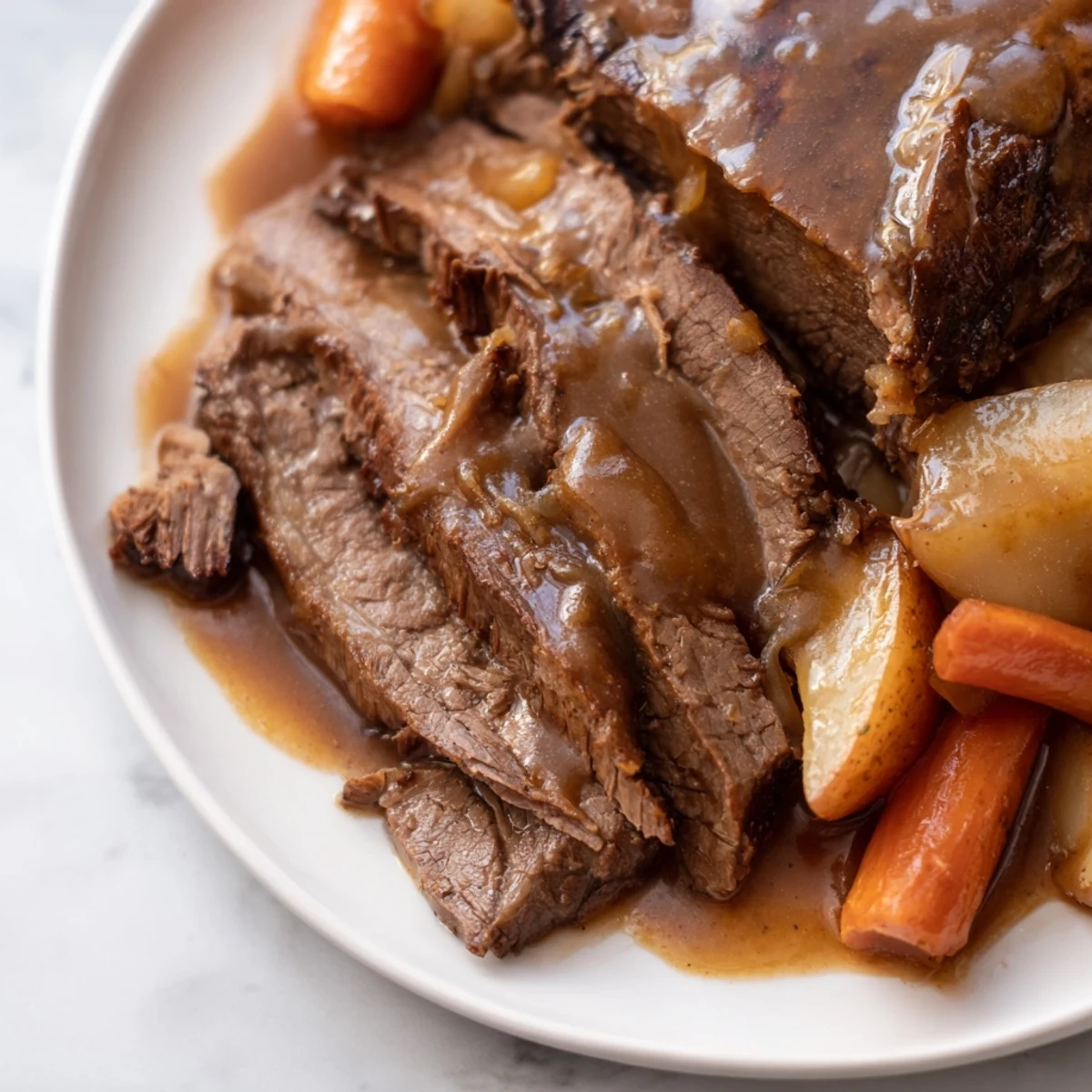 Golden Slow Cooker Pot Roast with Gravy over potatoes and vegetables
