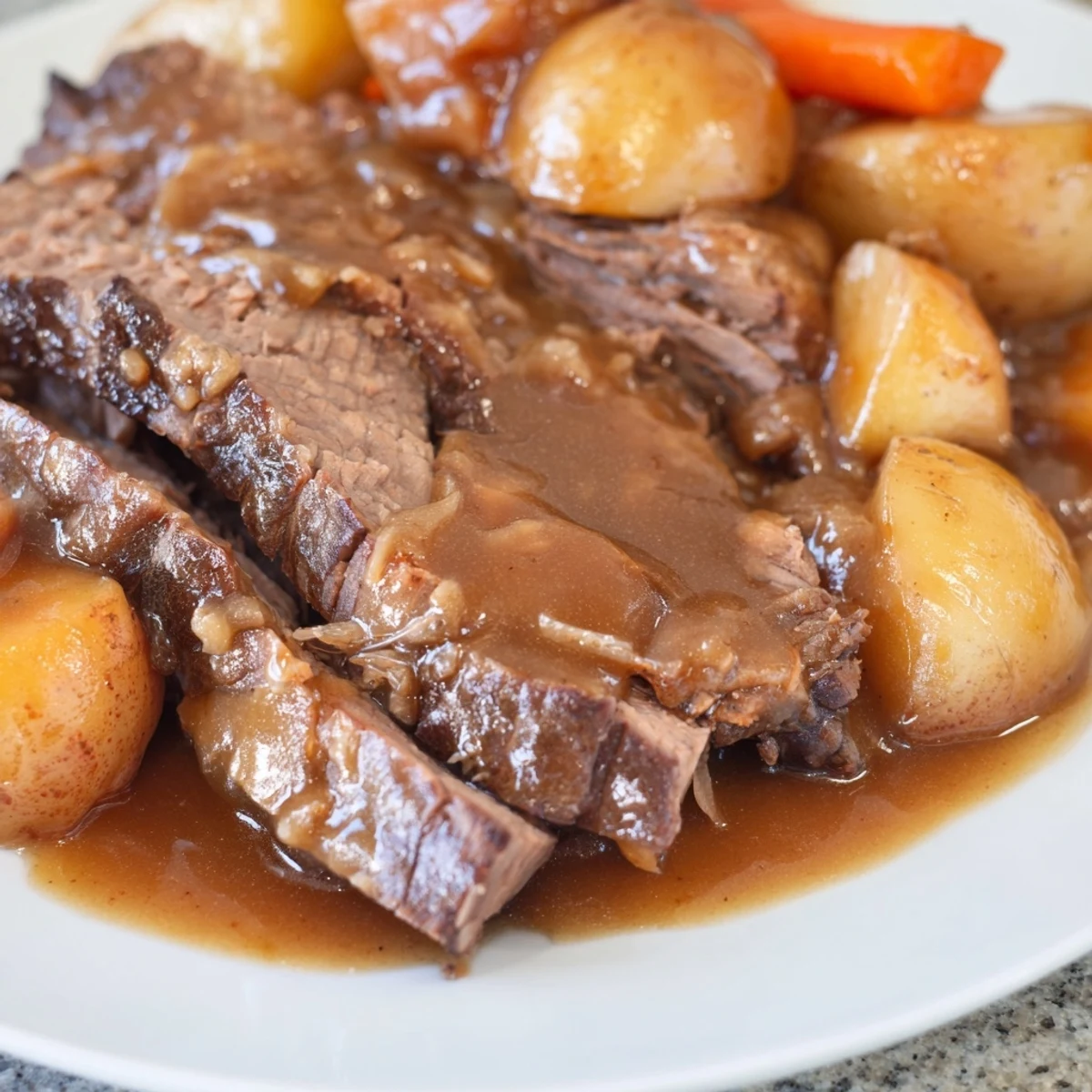 Tender Slow Cooker Pot Roast with Gravy and carrots on a platter