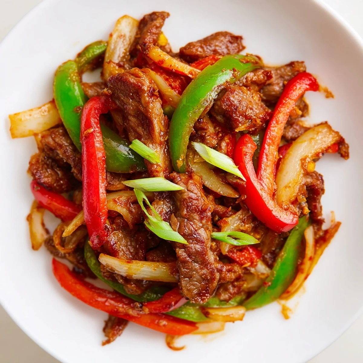 Tender beef and colorful vegetables tossed in a spicy glaze for this quick Spicy Stir Fry Beef main dish.