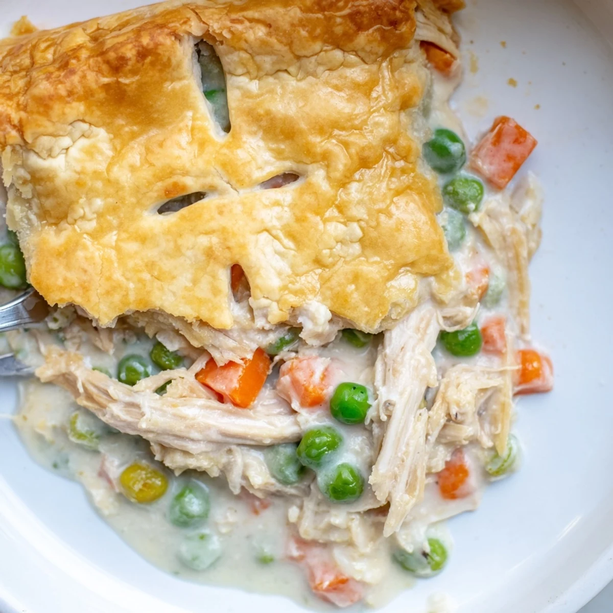 Hearty Chicken Pie Casserole served in a white dish, bubbling filling peeking from the crust.
