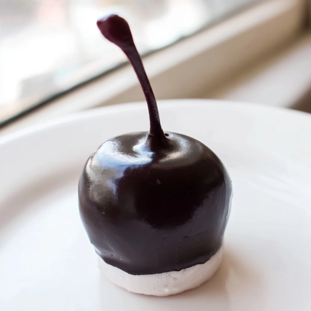 Plump Valentine Chocolate Covered Cherries resting on parchment, with rich chocolate shells and a hint of coconut shine.