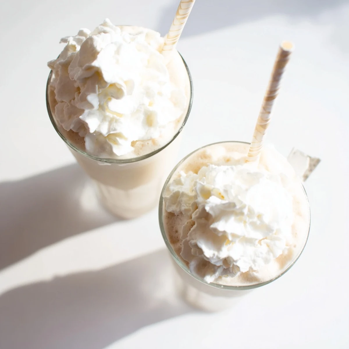 Creamy Starbucks Vanilla Bean Frappuccino topped with whipped cream served in a tall glass with a straw.