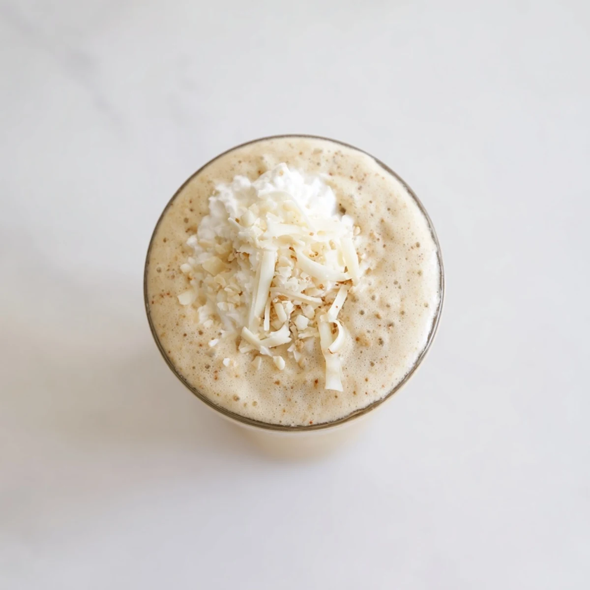 Refreshing Vanilla Bean Frappuccino poured into glasses, ready to serve with a straw and toppings.