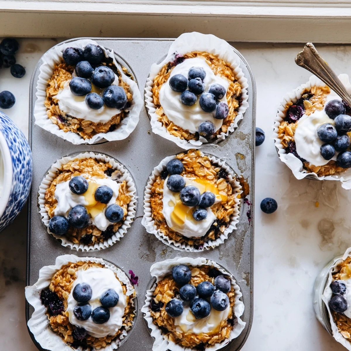 Freshly baked oatmeal cups topped with creamy Greek yogurt and fresh berries.  