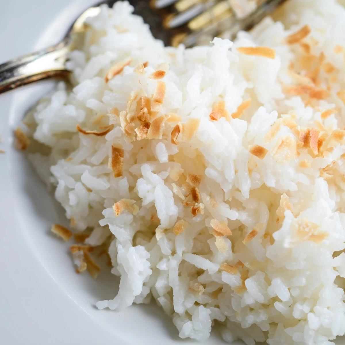 The Best Coconut Rice steaming gently beside grilled chicken and vibrant vegetables for a balanced meal