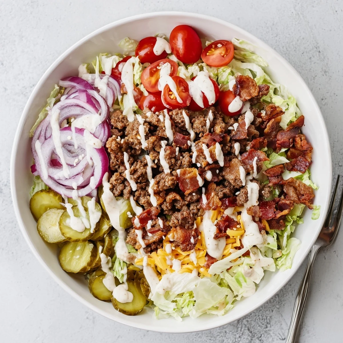 Colorful Smash Burger Bowl with crisp lettuce, cherry tomatoes, pickles, and melted cheddar cheese. 