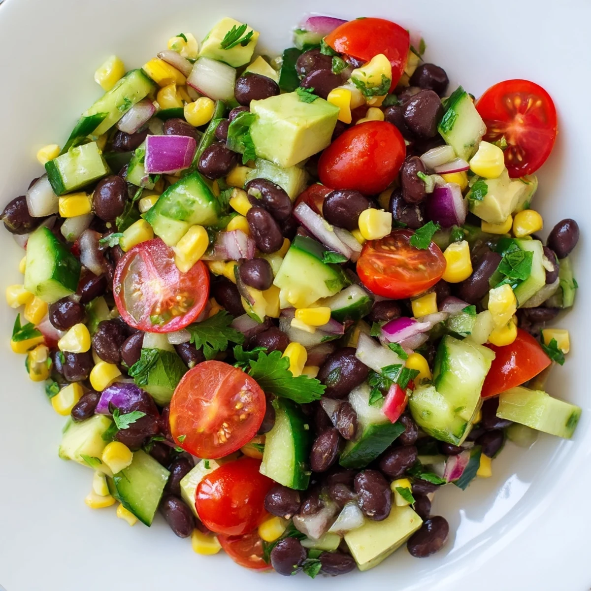 Colorful chopped black bean salad bowl with crisp vegetables and zesty lime drizzle