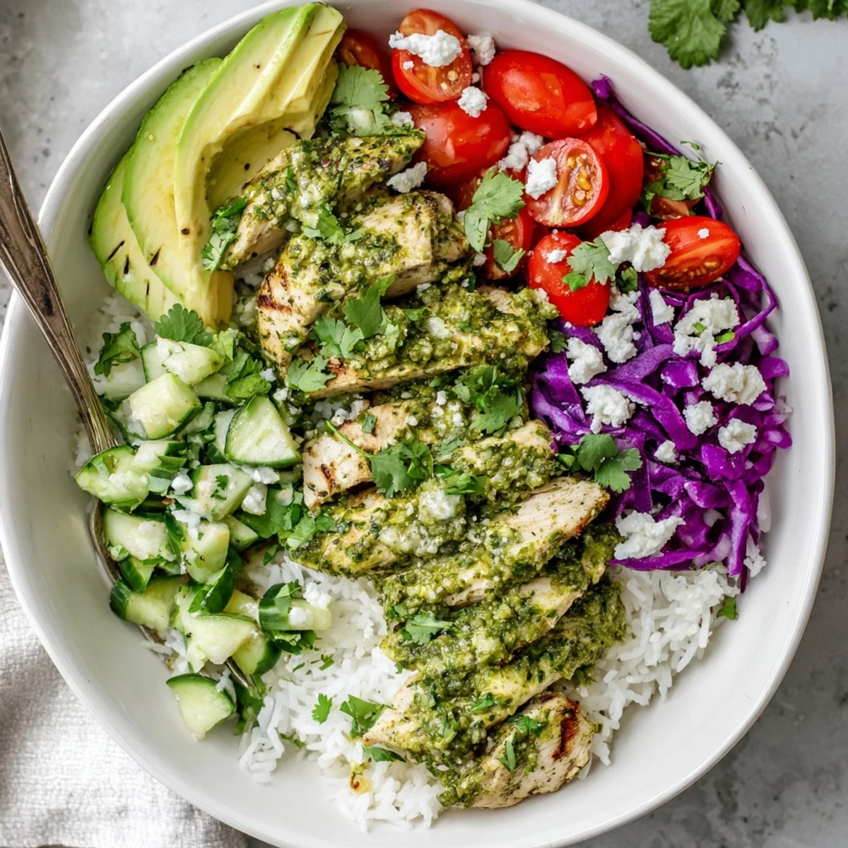 Latin American inspired chimichurri grilled chicken bowl topped with creamy garlic sauce and vibrant garden produce