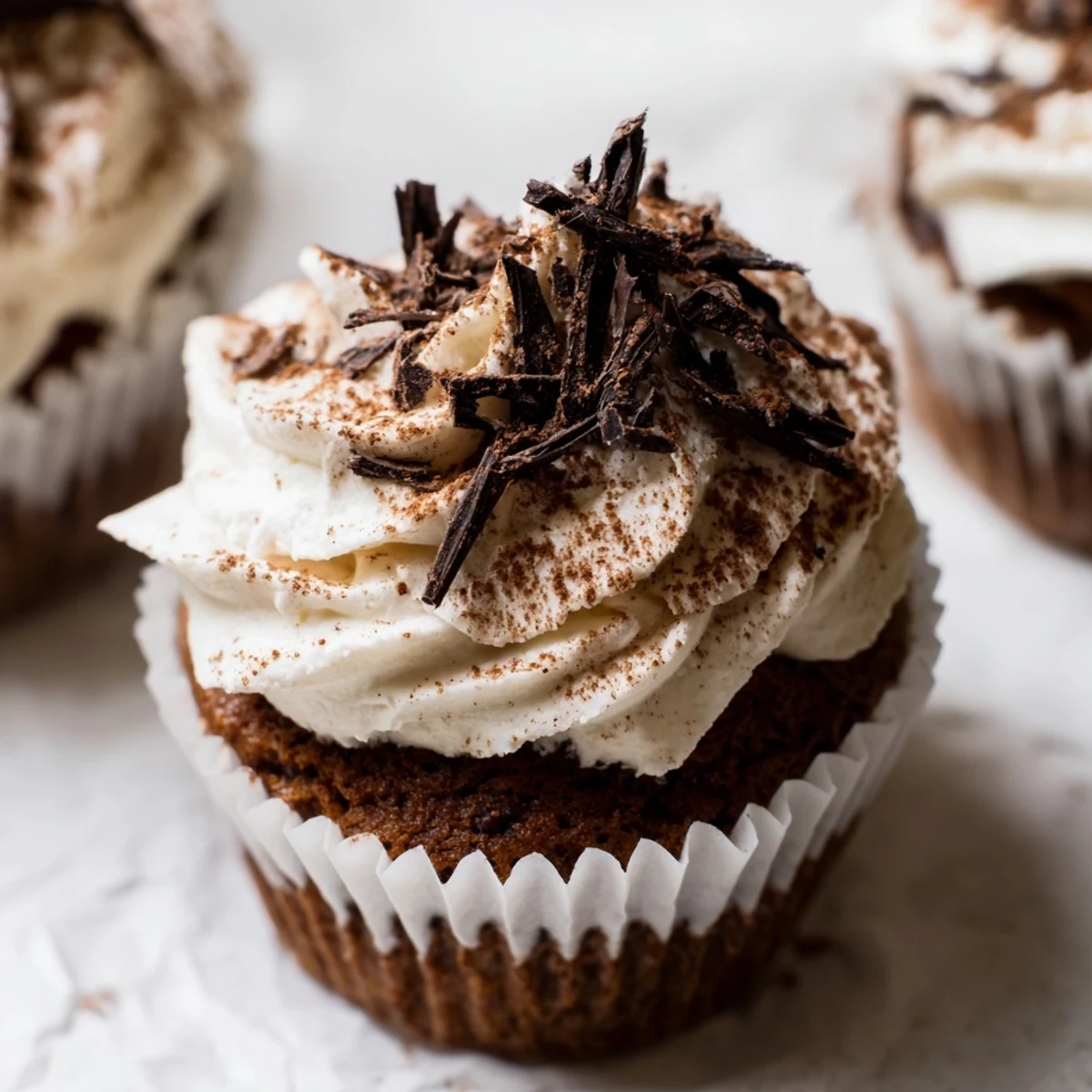 Decadent chocolate tiramisu cupcakes topped with fluffy mascarpone frosting and dusted cocoa powder