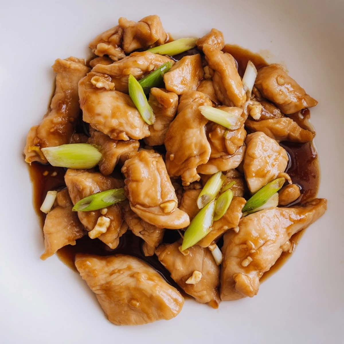 Tender stir-fried Mongolian chicken swimming in sweet savory hoisin sauce served over fluffy white steamed rice