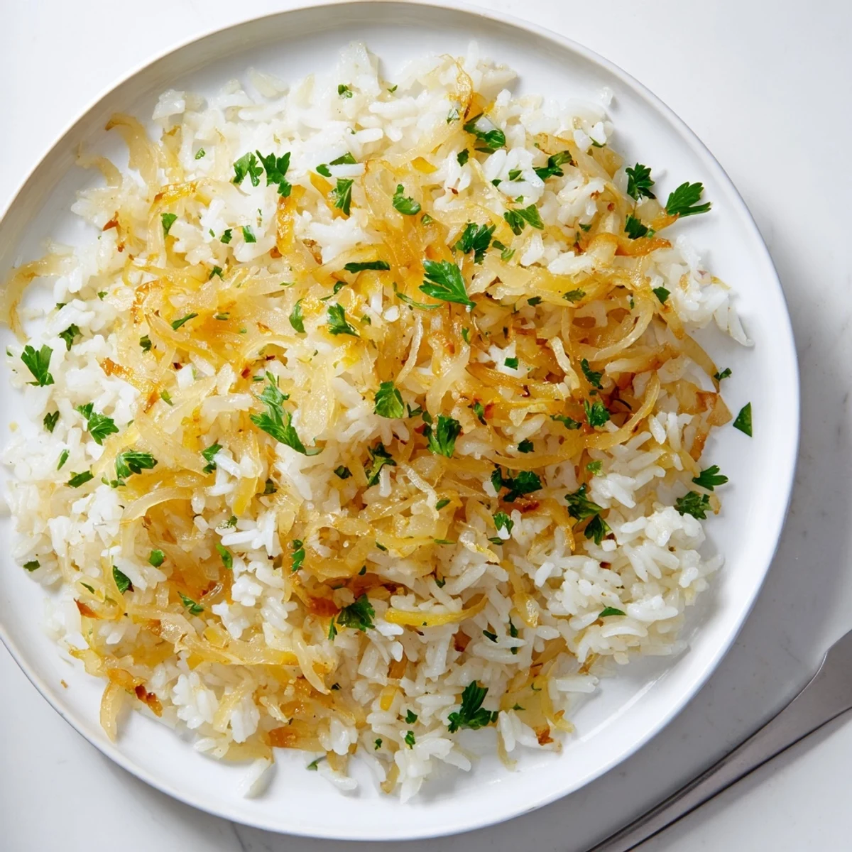 Fluffy white rice simmered with caramelized onions and aromatic herbs in a white bowl