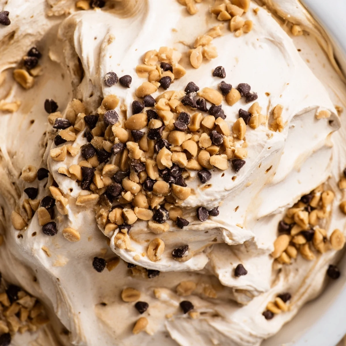 Velvety smooth peanut butter dessert mousse chilled in serving glasses with a crunchy peanut topping
