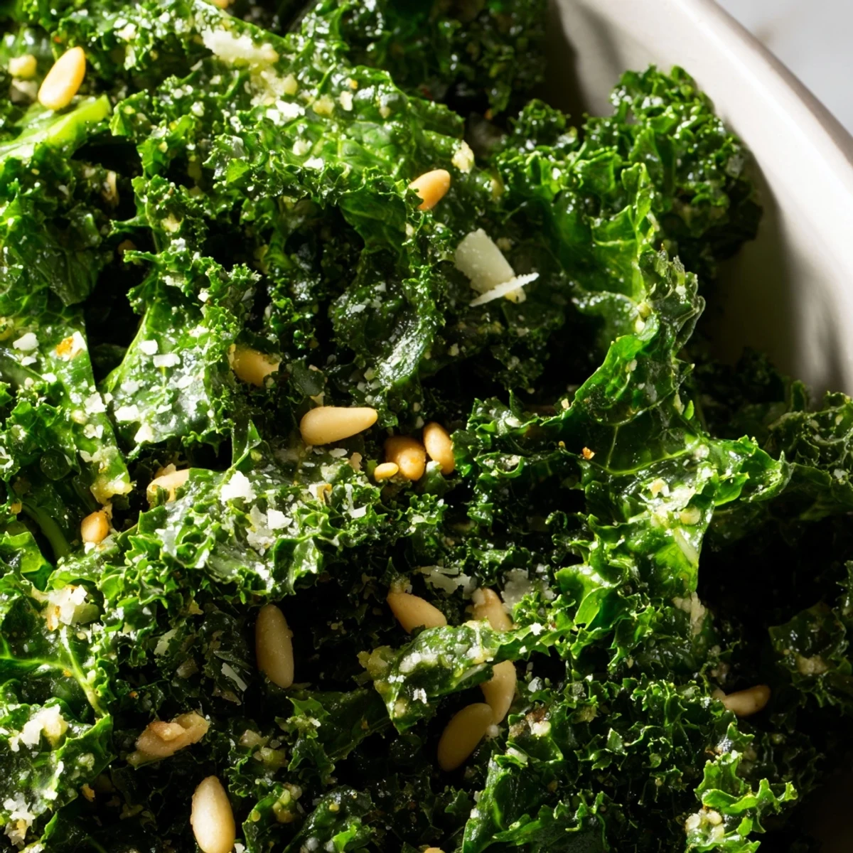 Massaged kale leaves glistening with zesty Garlic Lemon Parmesan dressing topped with crunchy almonds