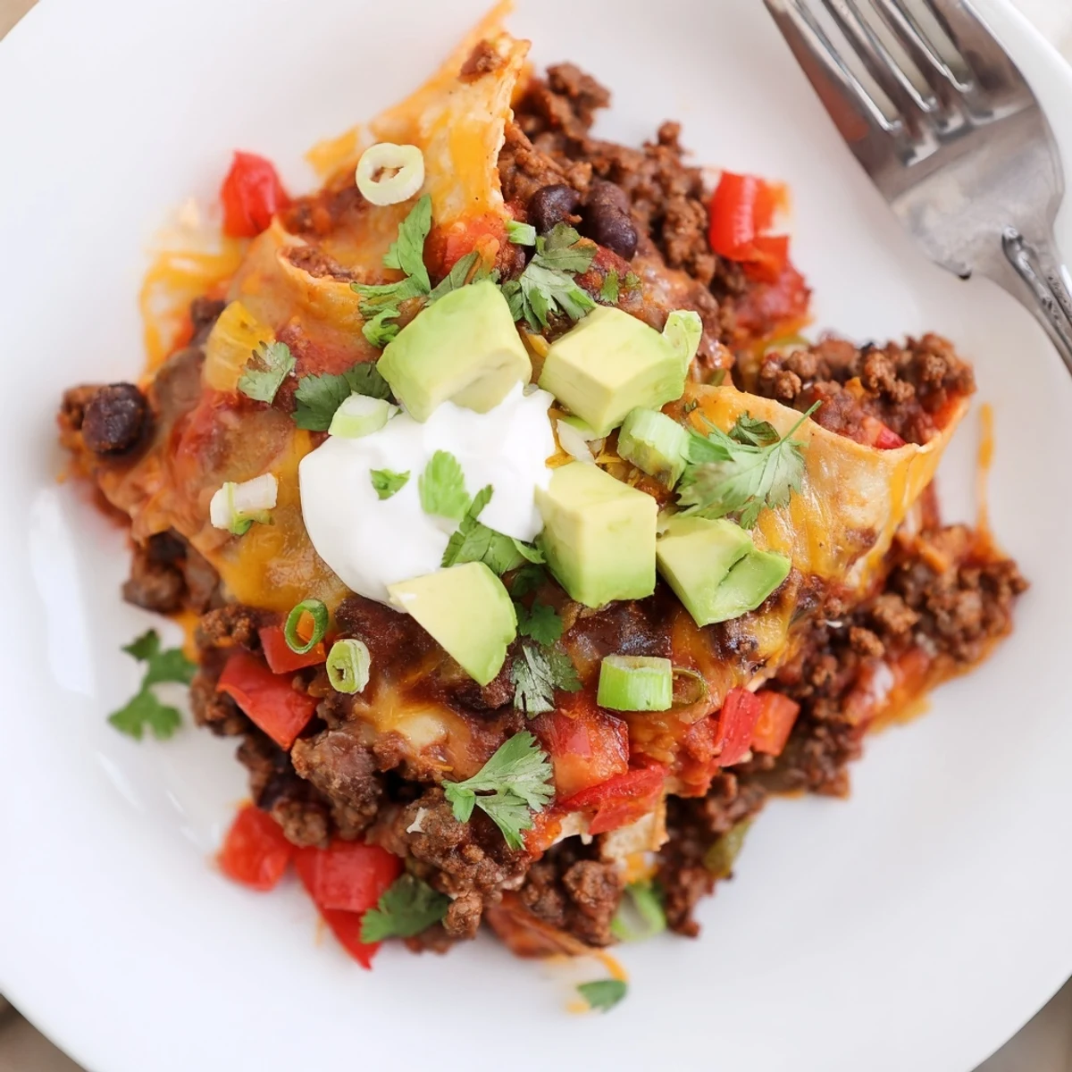 Hearty Beef Skillet Enchiladas with spiced beef, charred tortilla edges, smoky aroma