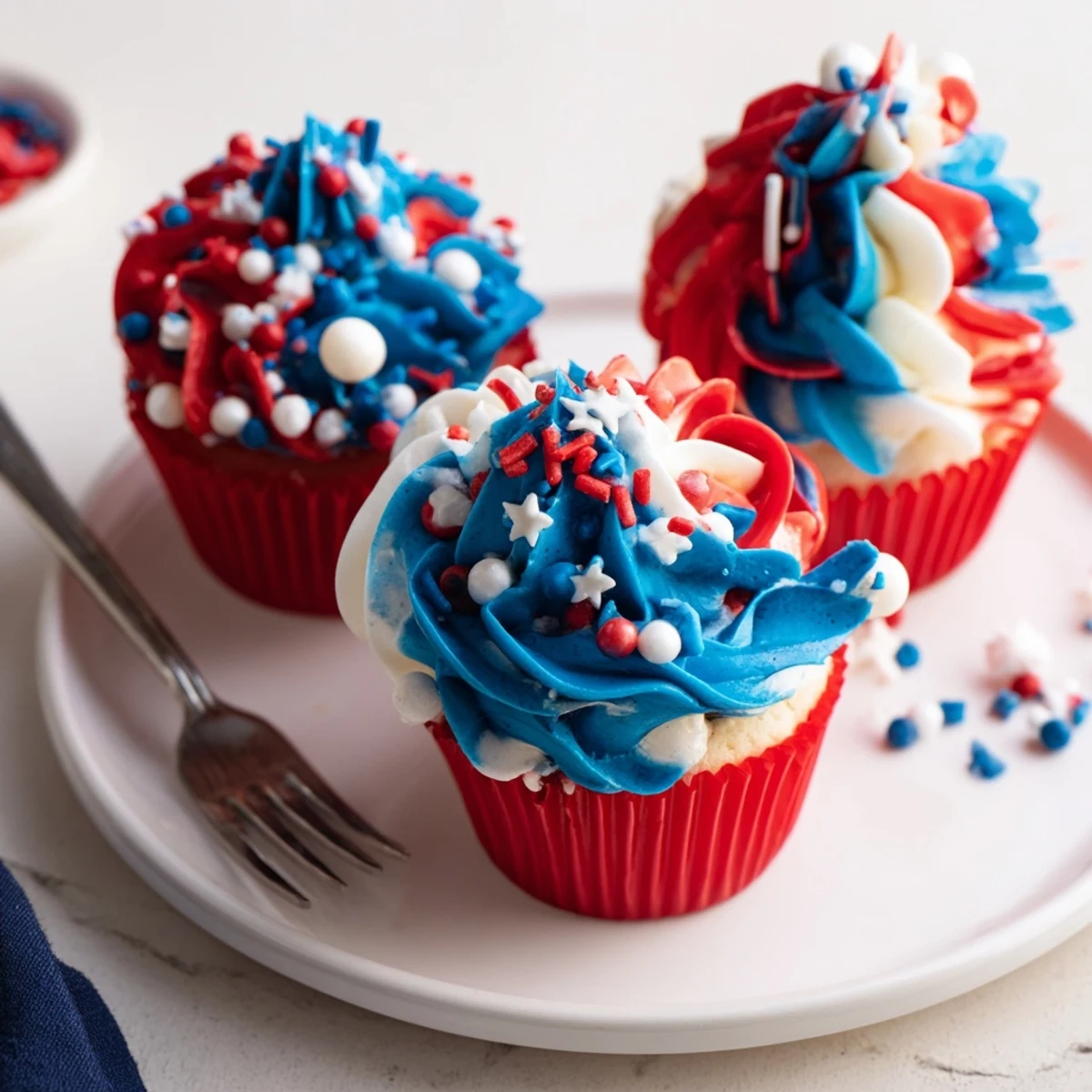 Patriotic Firework Cupcakes with tall red, white, blue buttercream swirls  