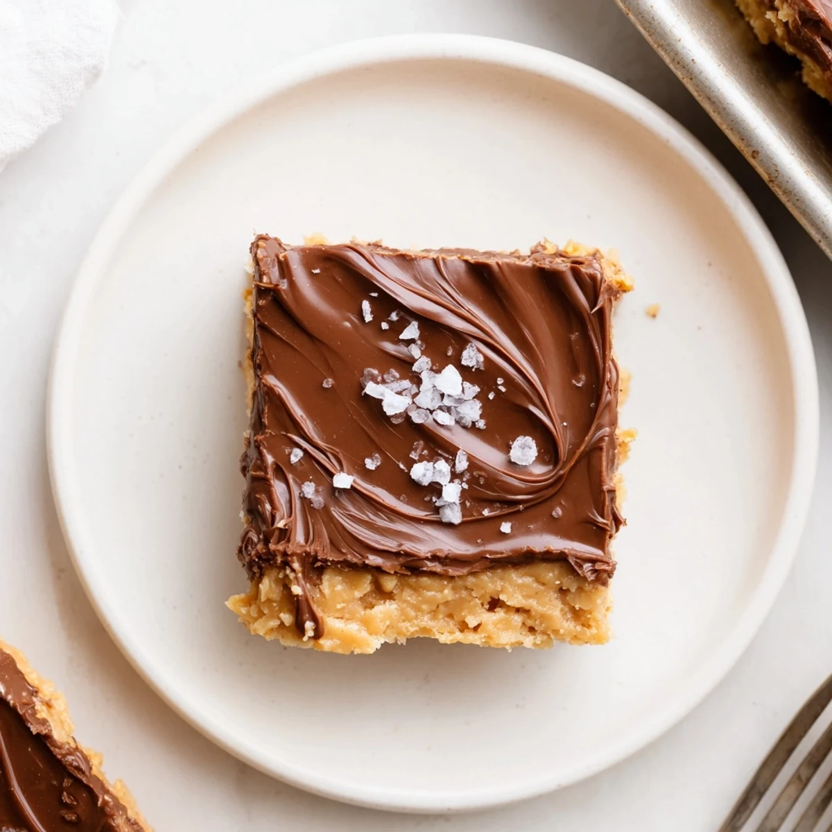 No Bake Peanut Butter Bars with glossy chocolate topping and creamy peanut center