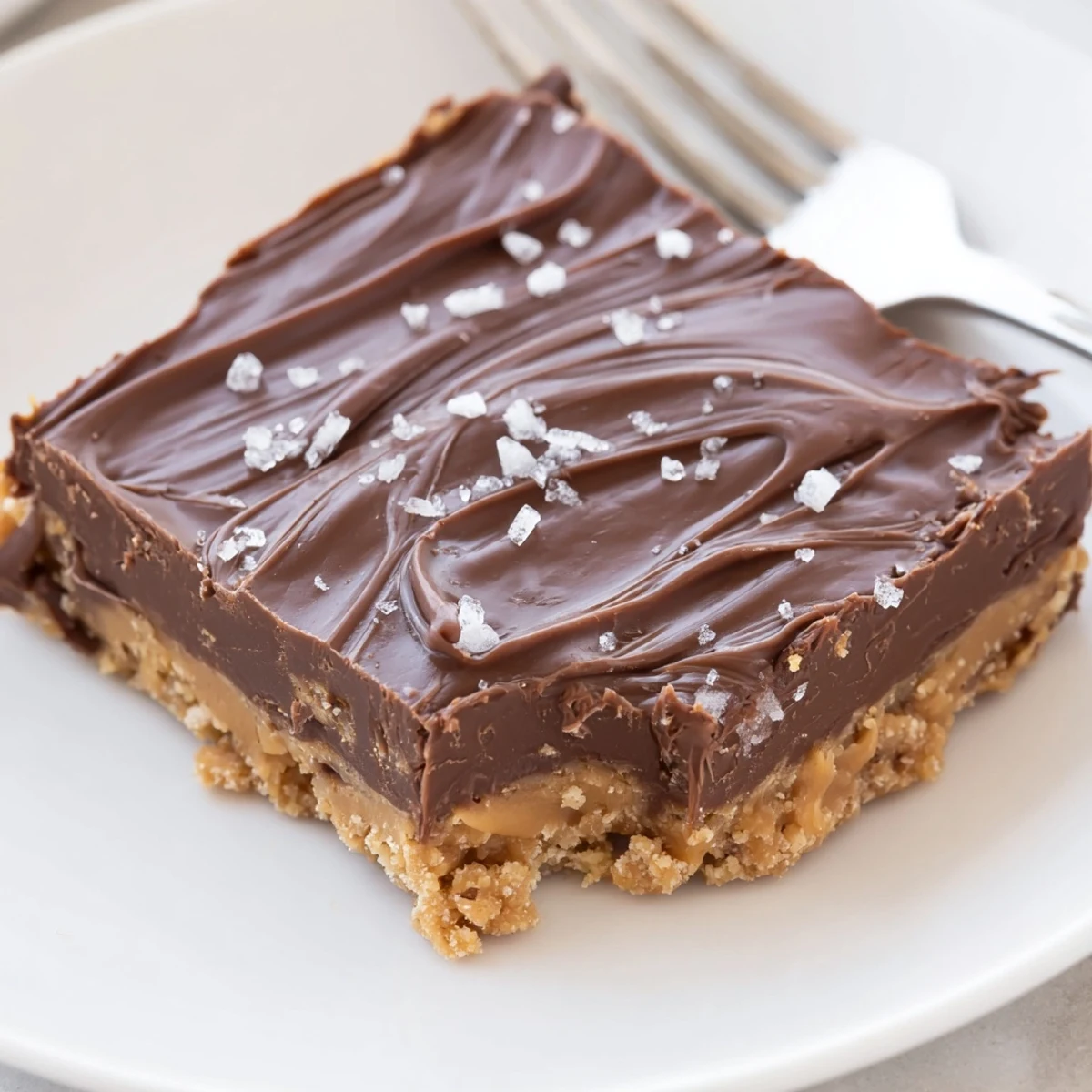 Chunky salt-sprinkled No Bake Peanut Butter Bars served on parchment, ready to enjoy