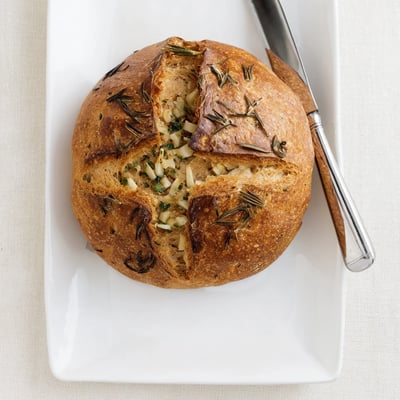 Rustic artisan Garlic Herb Dutch Oven Bread sliced open revealing tender crumb and aromatic minced garlic